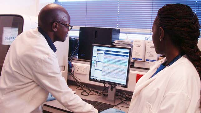Scientists analysing data at the South-South Malaria Research Partnership project laboratory in Kenya.
