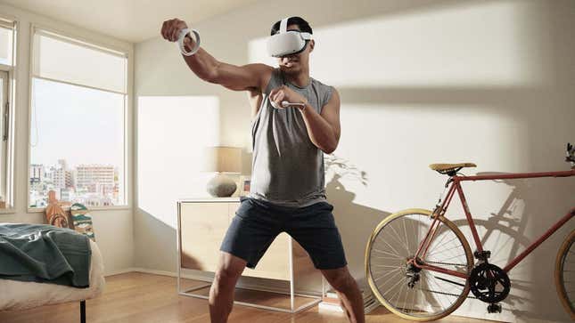 A photo of a man in his white apartment playing in VR using the Quest 2.