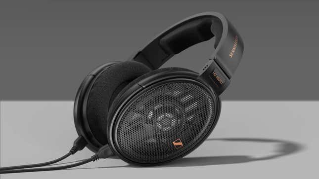 The Sennheiser HD 660S2 headphones sitting on a gray surface in front of a gray backdrop.