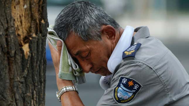 Photo of a man wiping his forehead