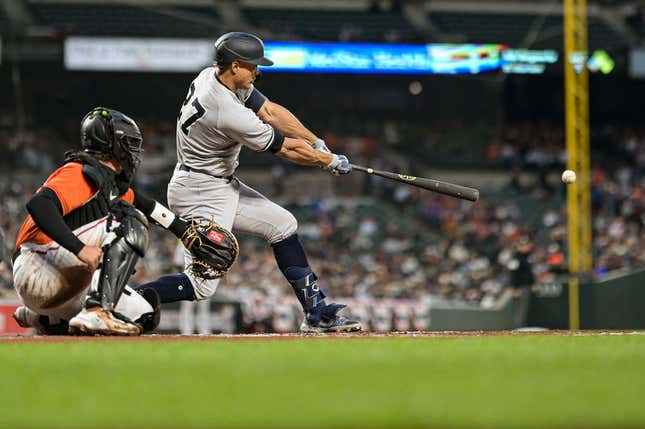Apr 8, 2023; Baltimore, Maryland, USA;  New York Yankees right fielder Giancarlo Stanton (27) hits a third inning single against the Baltimore Orioles at Oriole Park at Camden Yards.