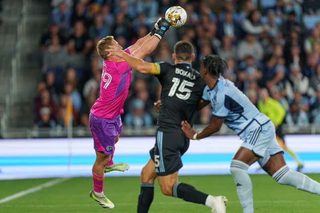 Sep 16, 2023; Saint Paul, Minnesota, USA; Sporting Kansas City goalkeeper Tim Melia (29) punches the ball away on a free kick in the first half with Minnesota United defender Michael Boxall (15) pressing at Allianz Field.
