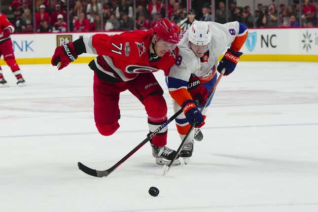Apr 19, 2023; Raleigh, North Carolina, USA; Carolina Hurricanes right wing Jesper Fast (71) and New York Islanders defenseman Noah Dobson (8) chase after the puck during the third period in game two of the first round of the 2023 Stanley Cup Playoffs at PNC Arena.