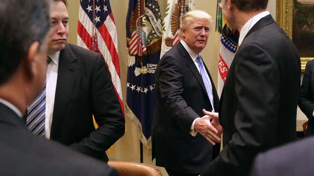 Former President Donald Trump greets Wendell Weeks of Corning, Elon Musk of SpaceX and other business leaders as he arrives for a meeting in the Roosevelt Room at the White House January 23, 2017, in Washington, DC.