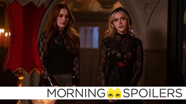 Cheryl Blossom and Sabrina Spellman stand together wearing ornate lace dresses.