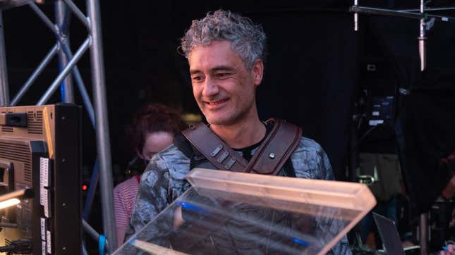 Taika smiling looking at a camera.