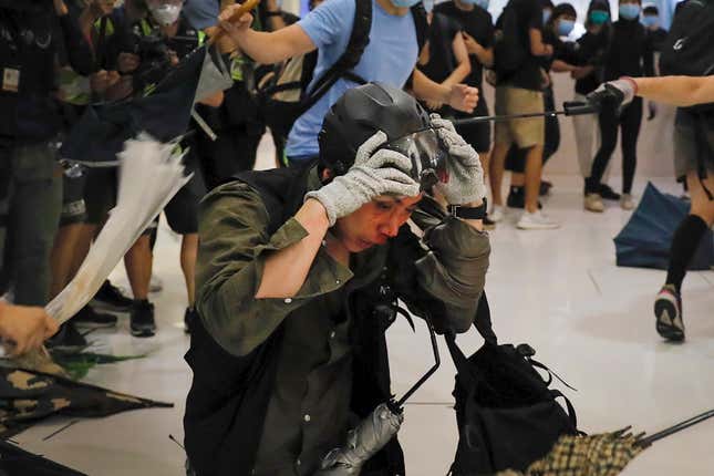 A policeman reacts after being attacked by protesters inside a mall in Sha Tin in Hong Kong, July 14, 2019.
