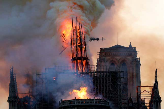 The spire of Notre Dame dramatically falling.