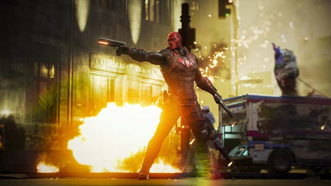 Red Hood is shooting his gun at someone off-screen as an explosion goes off behind him.