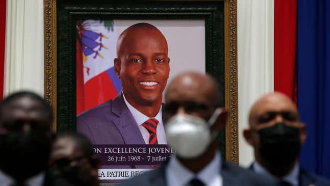 Authorities pose for a group photo in front of the portrait of late Haitian President Jovenel Moise at at the National Pantheon Museum during his memorial service in Port-au-Prince, Haiti. Moise was assassinated on July 7 at his home. Less than a dozen elected officials are currently representing a country of more than 11 million people.
