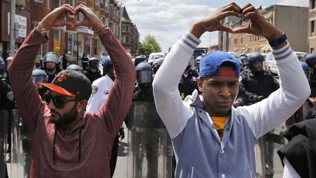 Hearts in the air in front of police. (Reuters/Jim Bourg)