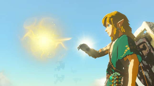 Link is seen holding his hand out to a golden light.