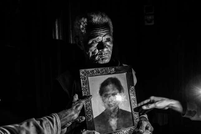 Martin Sauk shows a photo of his daughter Adelina Sauk, who was trafficked and later died in Malaysia.