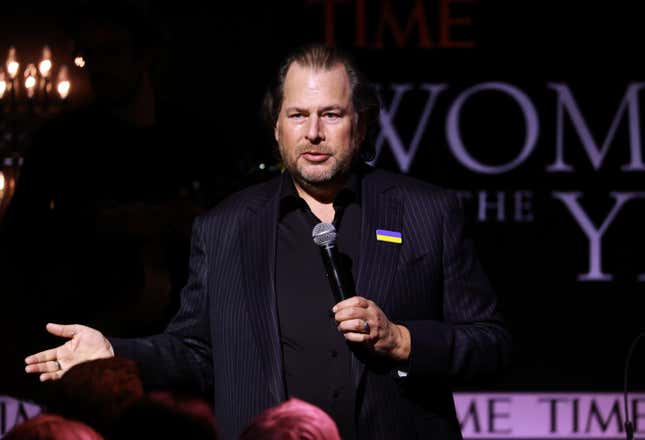Salesforce co-CEO Marc Benioff holds a microphone up to his mouth as he speaks.