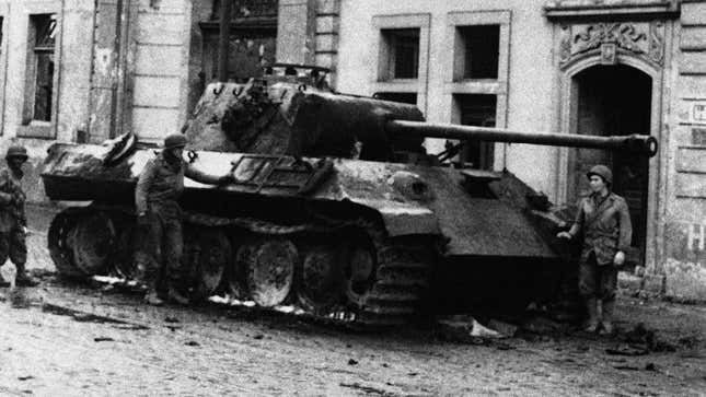 U.S. infantrymen inspect a burned-out Panther tank in front of the Beethoven Hall in Bonn, Germany on March 12, 1945.