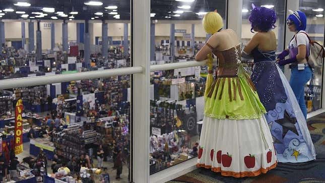 Three fans dressed in costume look down on the Florida SuperCon convention floor from 2015.