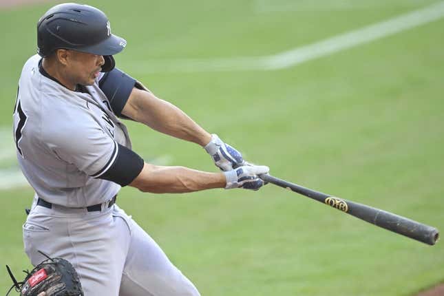 Apr 10, 2023; Cleveland, Ohio, USA; New York Yankees right fielder Giancarlo Stanton (27) hits a two-RBI double in the first inning against the Cleveland Guardians at Progressive Field.