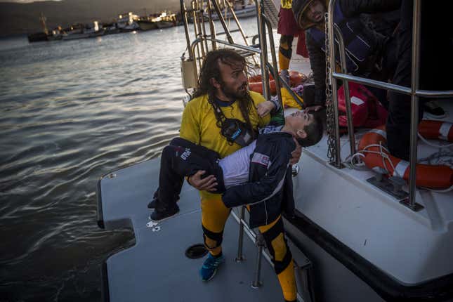 A volunteer carries a young boy. Oct. 28, 2015.