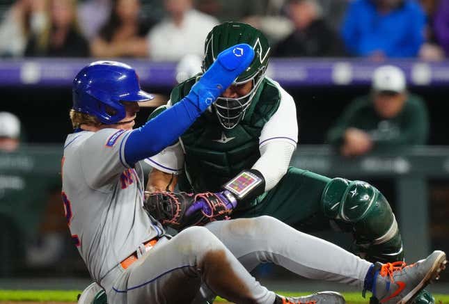 May 27, 2023; Denver, Colorado, USA; Colorado Rockies catcher Elias Diaz (35) tags out New York Mets third baseman Brett Baty (22) in the sixth inning at Coors Field.