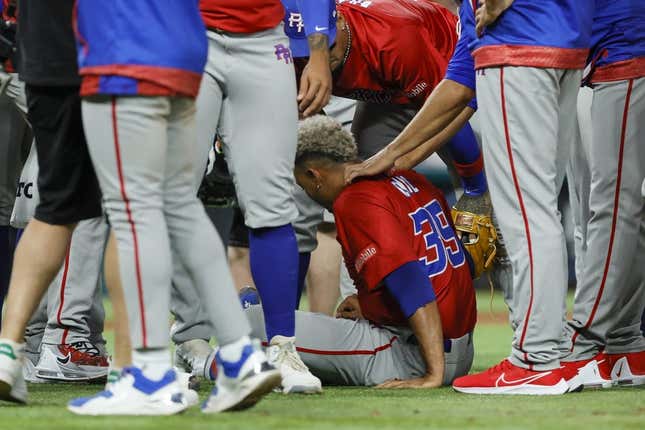 Mar 15, 2023; Miami, Florida, USA; Puerto Rico pitcher Edwin Diaz (39) sits on the field after an apparent leg injury during the team celebration against Dominican Republic at LoanDepot Park.