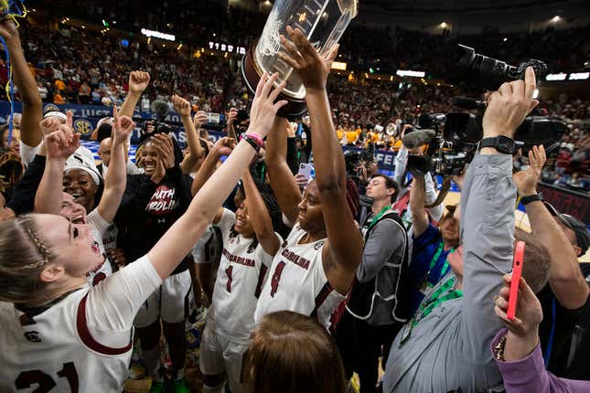South Carolina’s Aliyah Boston holds up the championship trophy after defeating Tennessee 74-58 to win the SEC Tournament.
