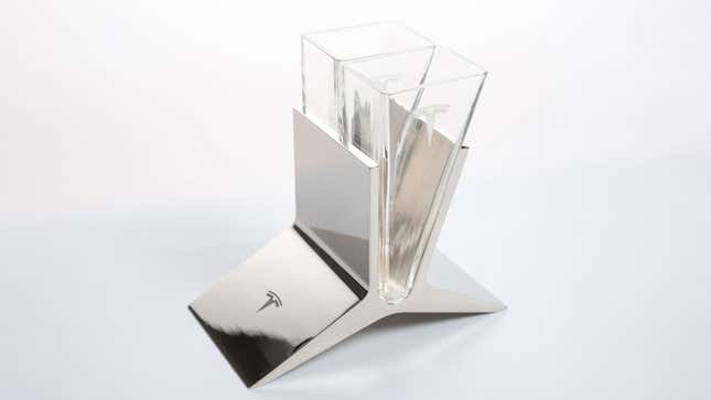A photo of two triangular Tesla glasses in a metal stand. 