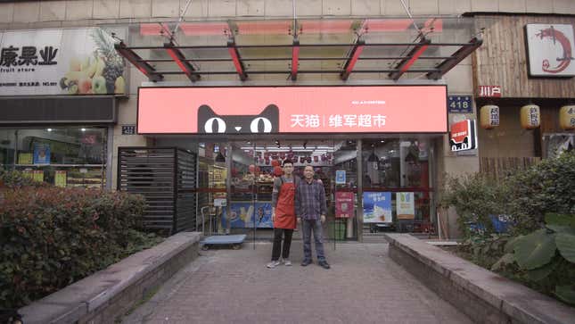 Hangzhou father and son in front of their convenience store.