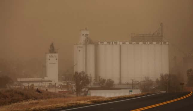 A grain elevator seen through the haze of the dust storm in Jetmore, Kansas.