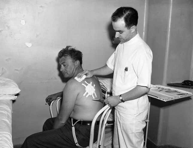 New York City detective Frederick Morelock has his left shoulder patched  up at Flushing hospital on July 5, 1940, after a piece of metal from a  bomb which exploded on July 4 at the New York World’s Fair tore into his  flesh.