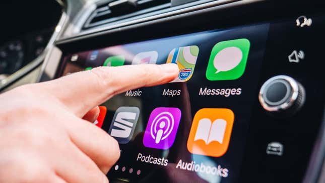 A driver using CarPlay on the dashboard display