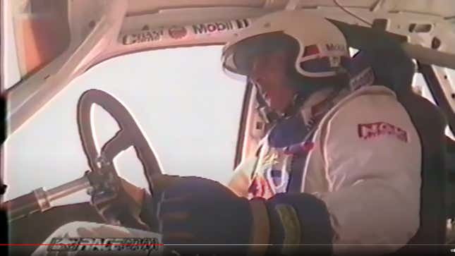 Australian race driver Peter Brock behind the wheel of a Holden Commodore
