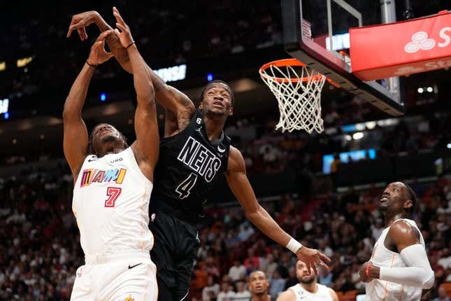 Mar 25, 2023; Miami, Florida, USA; Miami Heat guard Kyle Lowry (7) and Brooklyn Nets guard Edmond Sumner (4) compete for a rebound during the second half at Miami-Dade Arena.