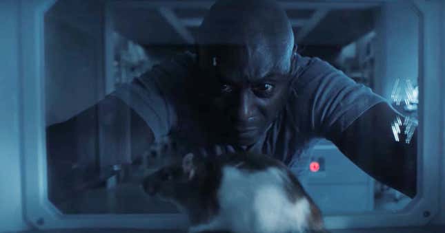 Lance Reddick as Albert Wesker in the Resident Evil series, staring at a rat.
