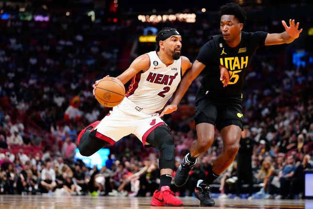 Mar 13, 2023; Miami, Florida, USA; Miami Heat guard Gabe Vincent (2) dribbles the ball past Utah Jazz center Damian Jones (15) during the third quarter at Miami-Dade Arena.