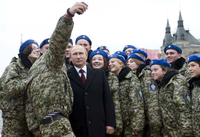 Putin poses for a selfie with members of a youth military patriotic club.