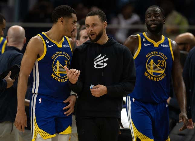 Feb 28, 2023; San Francisco, California, USA; Golden State Warriors guard Jordan Poole (3) confers with injured teammate Stephen Curry during a timeout in the fourth quarter against the Portland Trail Blazers at Chase Center.