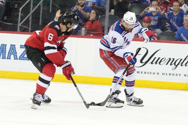 Apr 20, 2023; Newark, New Jersey, USA; New York Rangers center Vincent Trocheck (16) plays the puck against New Jersey Devils defenseman John Marino (6) during the third period in game two of the first round of the 2023 Stanley Cup Playoffs at Prudential Center.