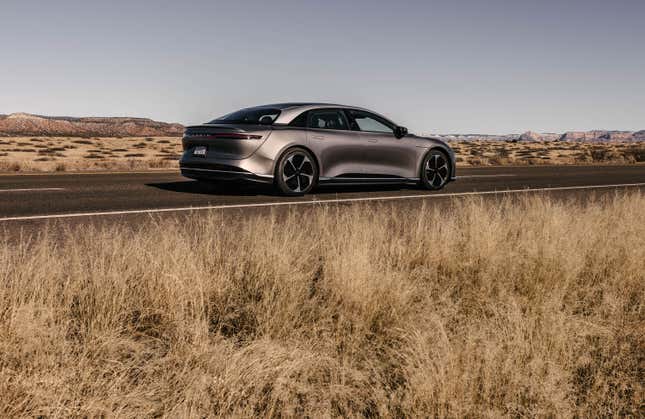 A gray 2023 Lucid Air Touring is driving in the desert.