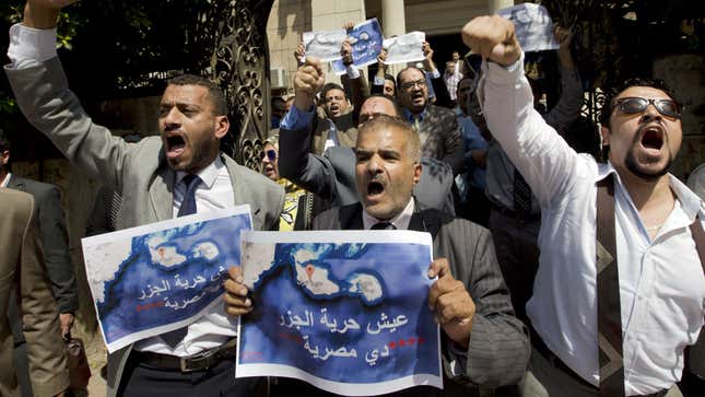 FILE - In this Tuesday, June 13, 2017, file photo, dozens of lawyers shout slogans during a protest against the accord to hand over control of two strategic Red Sea islands, Tiran and Sanafir, to Saudi Arabia in front of the lawyers syndicate in Cairo. The tempestuous parliament approval of a deal transferring two Red Sea islands to Saudi Arabia is putting Egypt’s government at odds with the judiciary and providing the country’s battered opposition a nationalist cause to whip up at a time of growing economic distress. Arabic on the Red Sea map reads, " bread.. freedom, the islands are Egyptians".