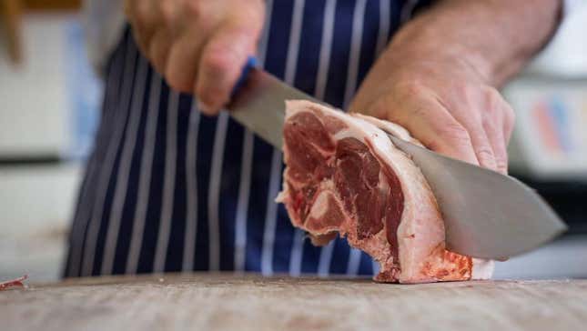 Butcher slicing meat