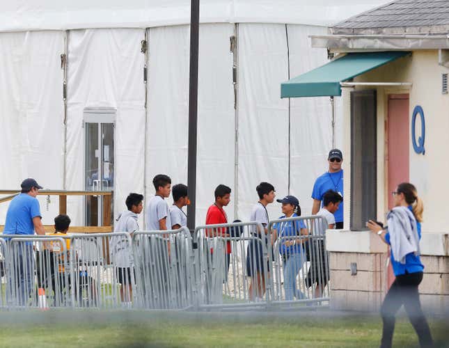 Unaccompanied children line up outside the Homestead Temporary Shelter for Unaccompanied Children.