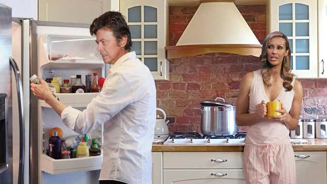 The man who once played the role of a pansexual alien and came to drunken blows with Lou Reed in a restaurant, looks through the fridge with his wife, a Somali supermodel. 