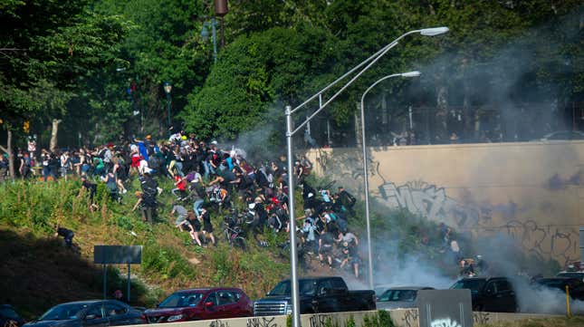 Protesters flee as they are tear gassed by police near Center City in Philadelphia, Pennsylvania, on June 1, 2020.