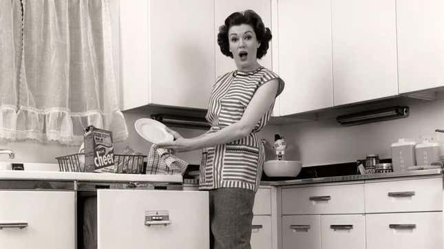 Black and white vintage photo of a woman unloading plates from a dishwasher with amazed expression