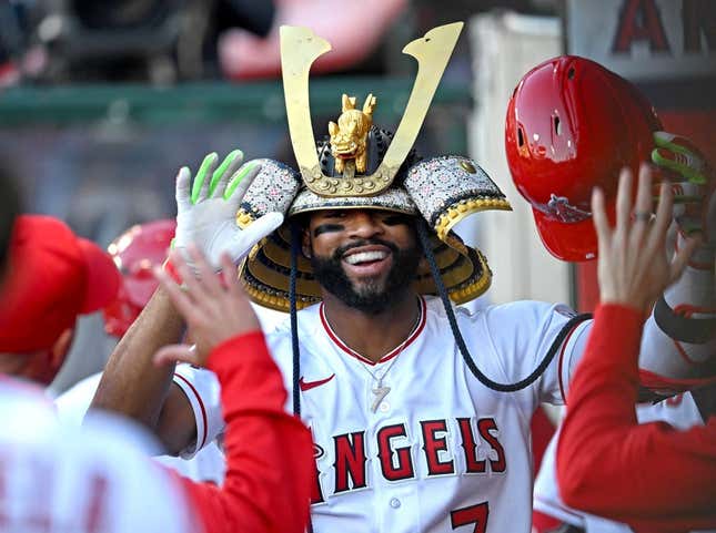 Jun 8, 2023; Anaheim, California, USA;  Los Angeles Angels right fielder Jo Adell (7) is congratulated in the dugout after hitting a solo home run in the second inning against the Chicago Cubs at Angel Stadium.