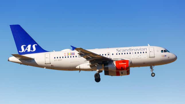 Scandinavian Airline plane flying in a clear blue sky