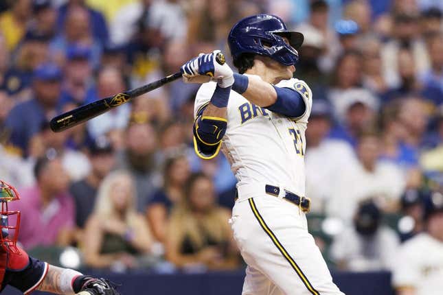 Aug 22, 2023; Milwaukee, Wisconsin, USA;  Milwaukee Brewers left fielder Christian Yelich (22) hits a double during the third inning against the Minnesota Twins at American Family Field.
