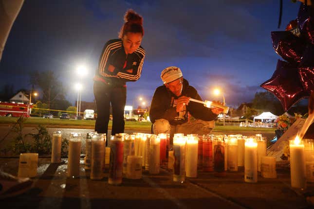 Mourners light candles at a makeshift memorial outside of Tops market on May 16, 2022, in Buffalo, New York.