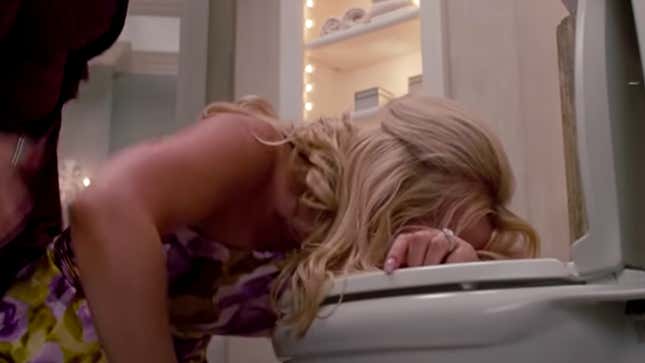 Screenshot of woman leaning over toilet