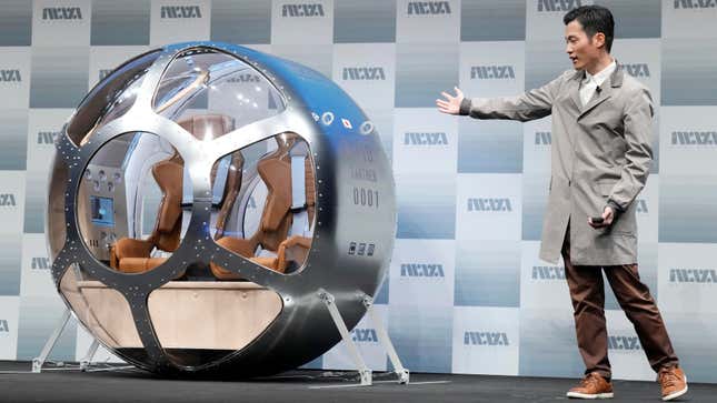 Keisuke Iwaya, CEO of a Japanese space development company, Iwaya Giken, unveils the commercial space viewing capsule during a conference in Tokyo.